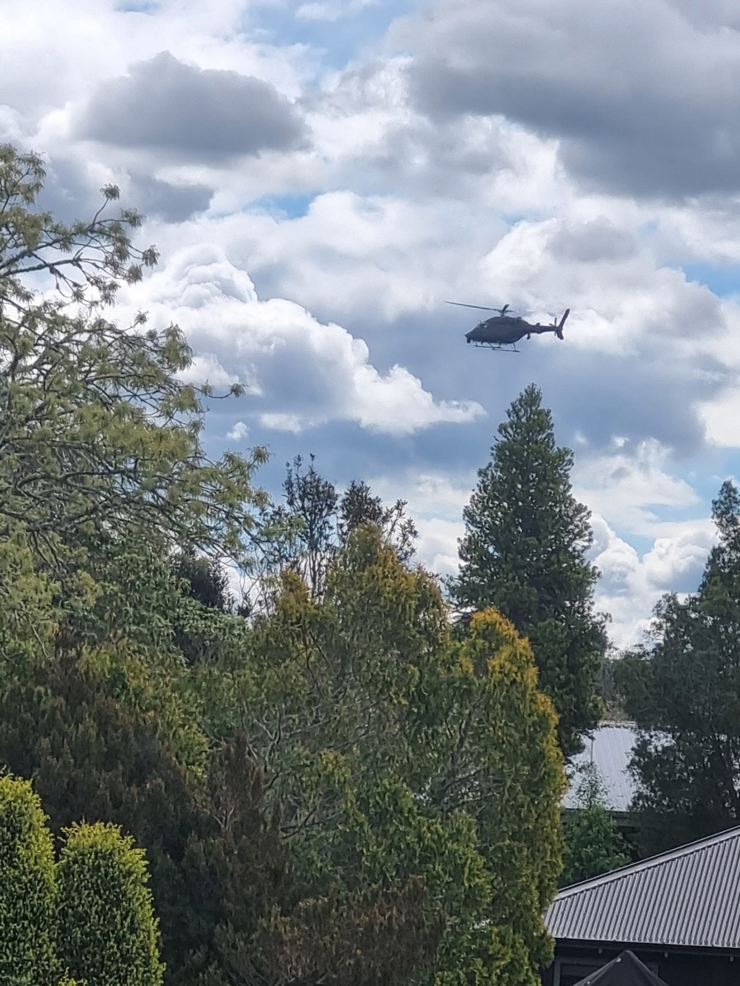 The police Eagle helicopter flying above trees in Cambridge