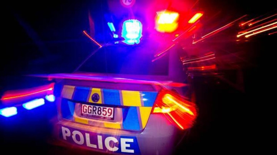 A police car at night with its emergency lights flashing