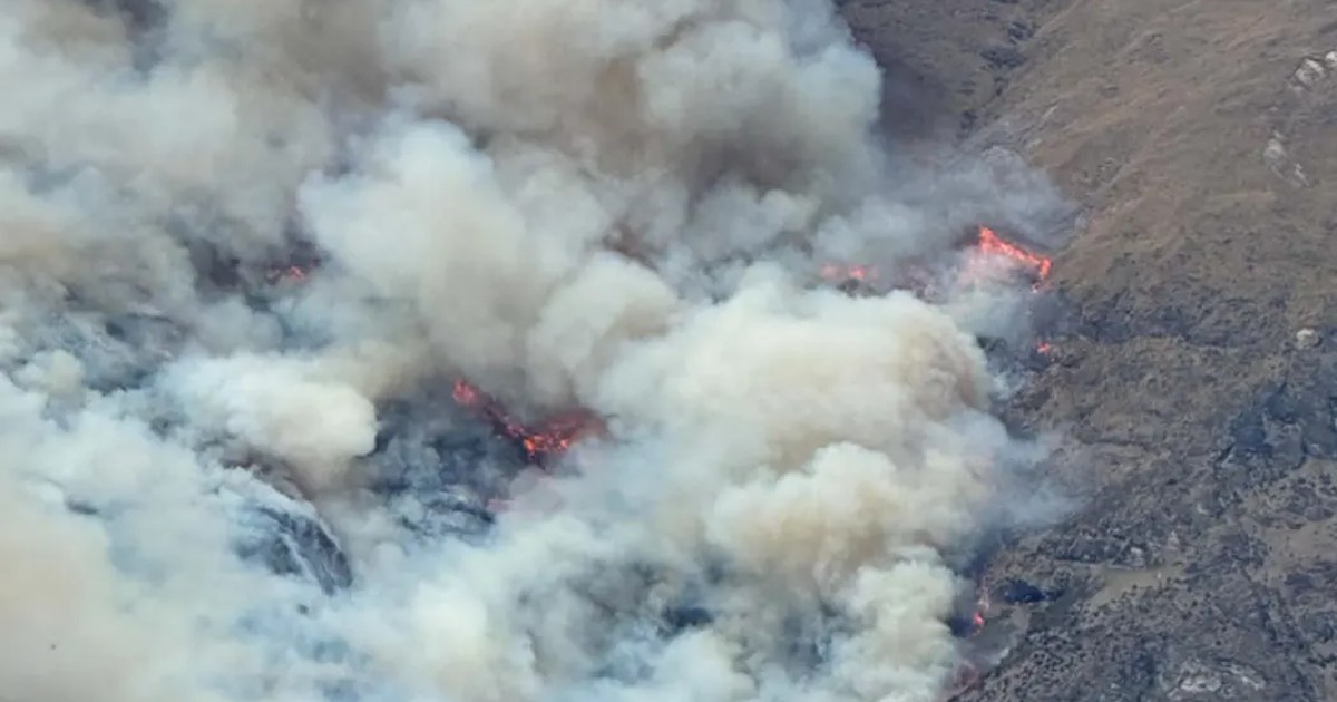 Thick smoke and visible flames on the steep slopes above Walter Peak station
